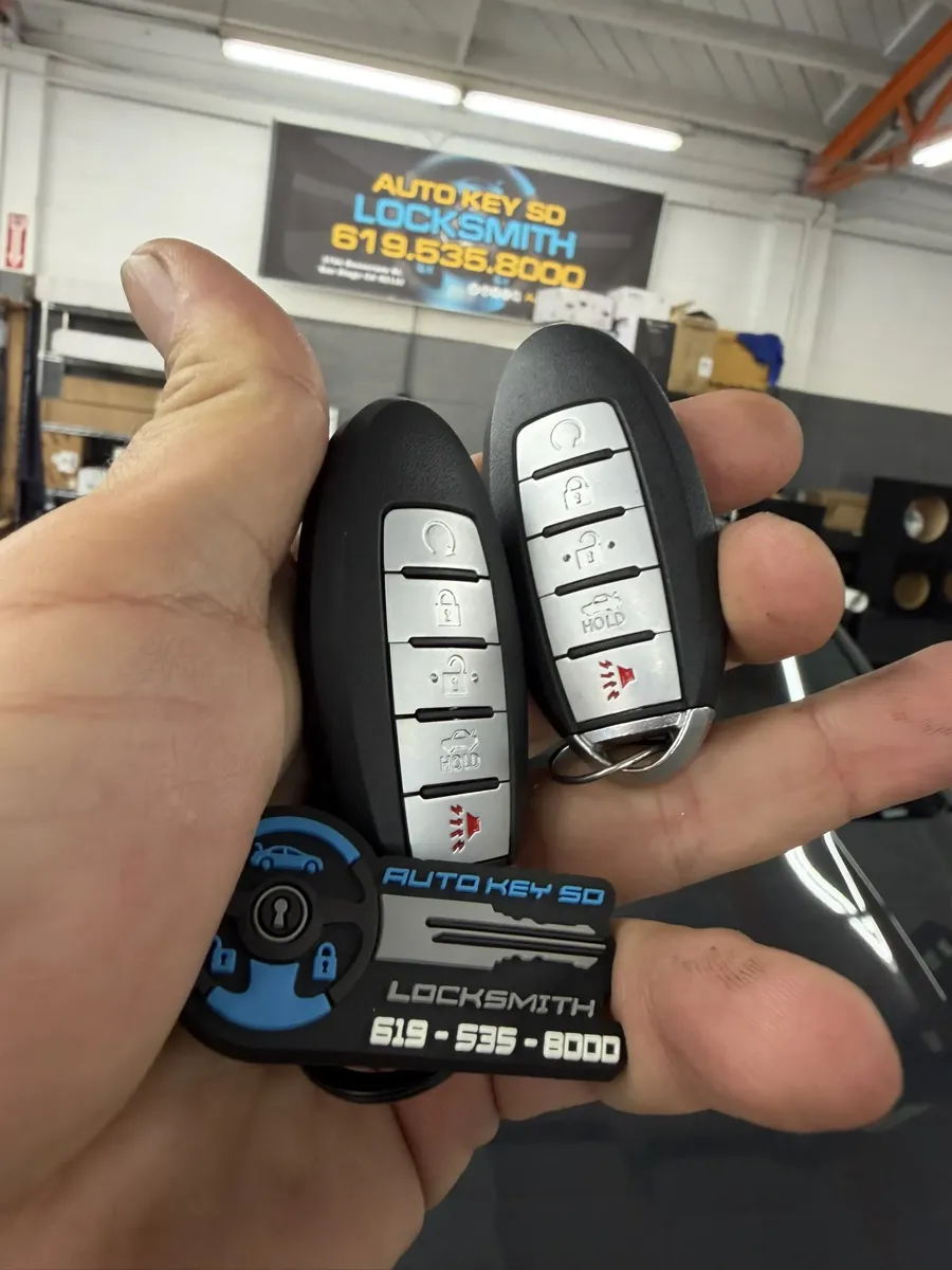 Nissan smart keys in front of the Auto Key SD sign