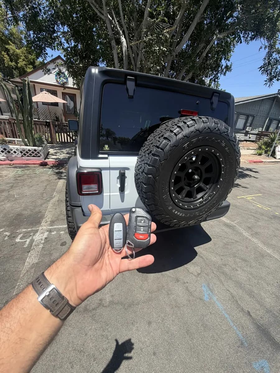Jeep Wrangler key fob held behind the Jeep in Mission Hills