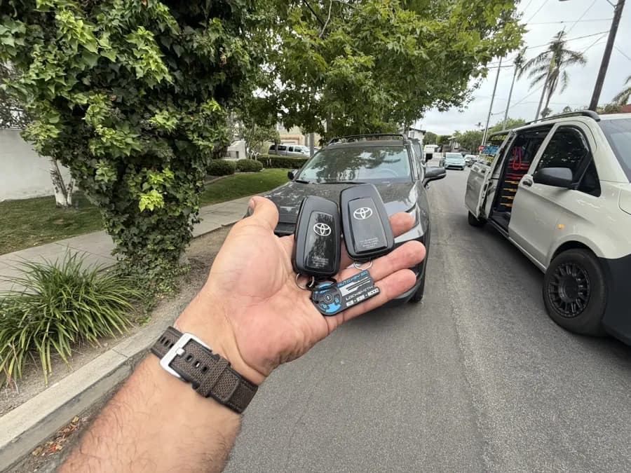 Two Toyota RAV4 smart keys with the Auto Key SD van alongside