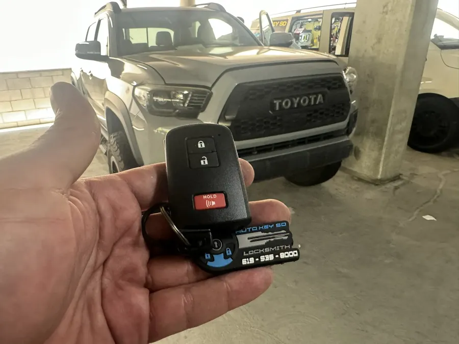 Toyota Tacoma smart key in a parking garage with the van behind